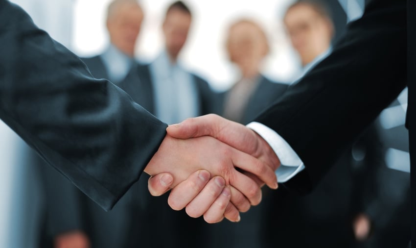 Handshake in front of business people