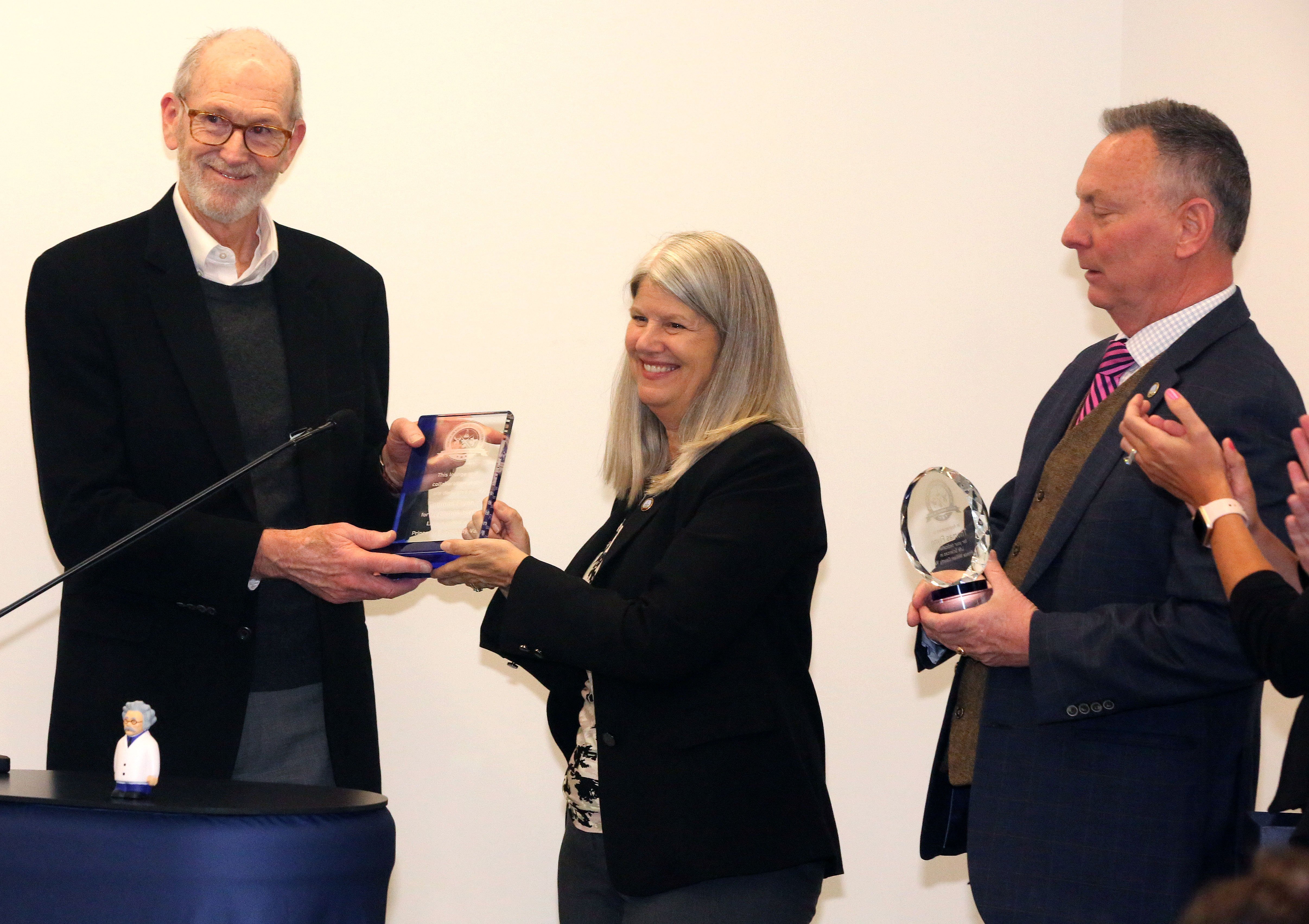 PWCDED Tom Flynn receives dedication award from Chair Wheeler and Holladay Partners Senior Vice President Austin Haynes