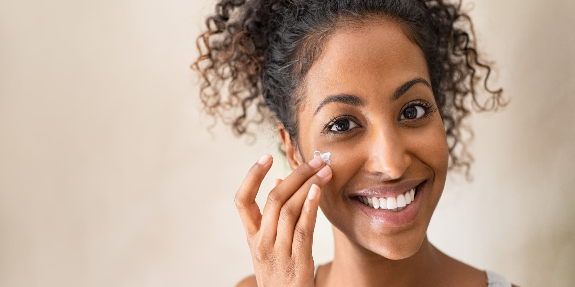 Model applies lotion with chemical products. 