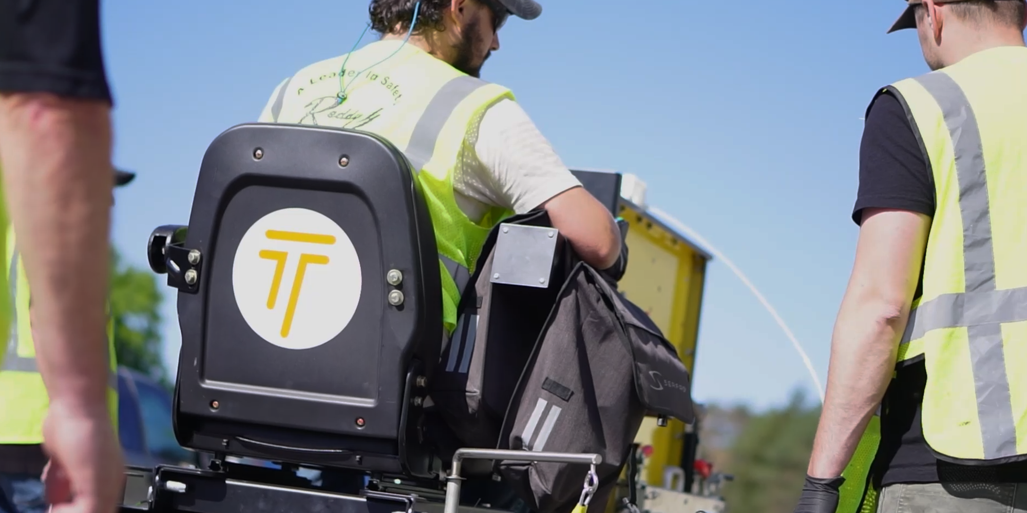 Image shows three people on the TRAXyL installer team from behind 