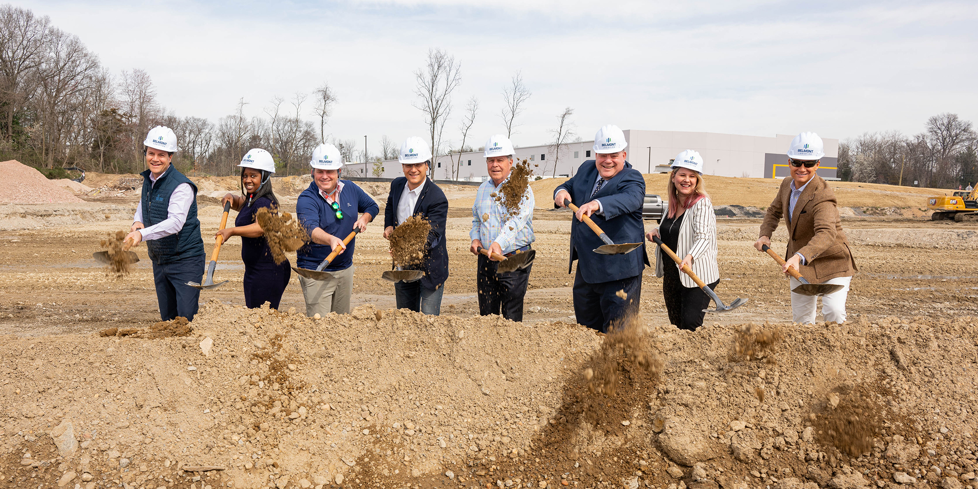 A group of Prince William County leaders throws dirt at a ceremonial groundbreaking. 